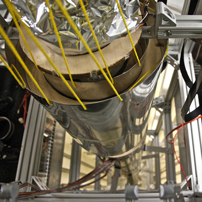 A top view of an atomic fountain is shown. It measures time using the vibration of the cesium atom.